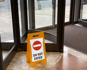 Persons Working Above Stand-Up Floor Signs