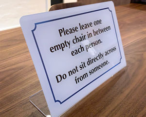 Do not sit across from anyone sign