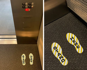 Elevator stand here footprint markers