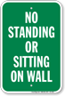 No Standing Or Sitting On Wall Sign