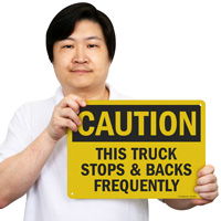 Caution: Truck Reverses Often Sign