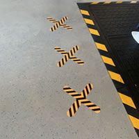 Floor signs with an X do not stand here symbol