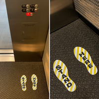 Elevator stand here footprint markers
